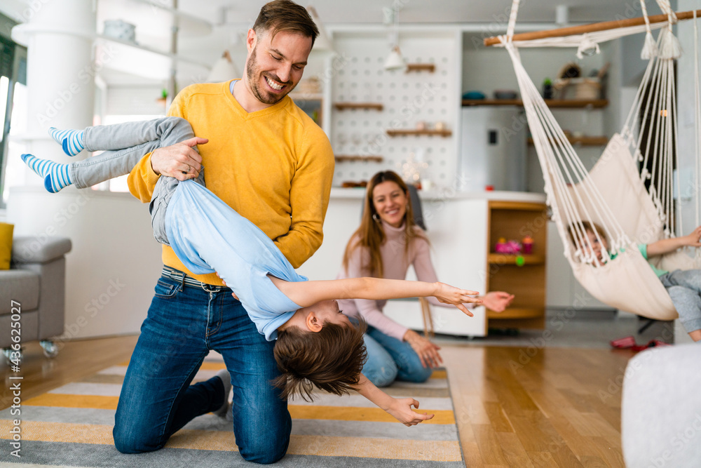 Obraz premium Happy young family having fun times and playing together at home