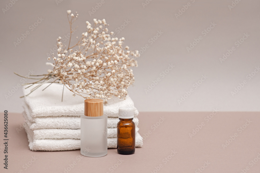 a set of towels and two jars on a light background, spa concept, moisturizing and nourishing the skin, body care, cosmetology and dermatology a set of towels and two jars on a light background, spa concept, moisturizing and nourishing the skin, body care, cosmetology and dermatology