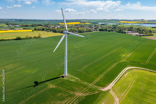 Photographie A wind turbine that produces electricity, built on a field in Skanderborg, Denma