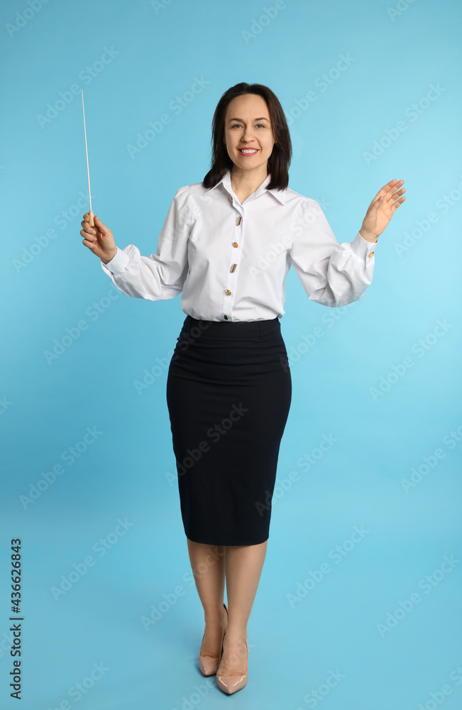Music teacher with baton on turquoise background Music teacher with baton on turquoise background