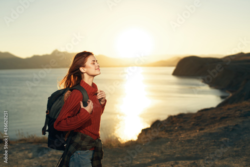 woman tourist with backpack outdoors landscape sunset travel