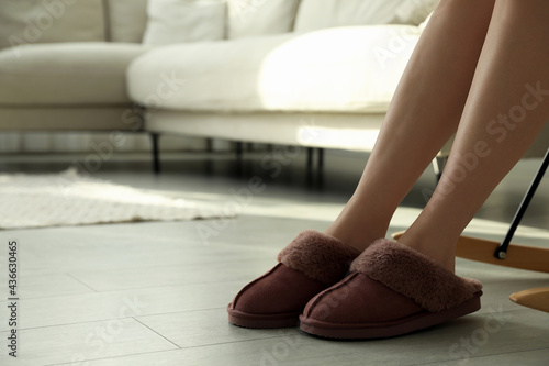 Woman in soft slippers at home, closeup. Space for text
