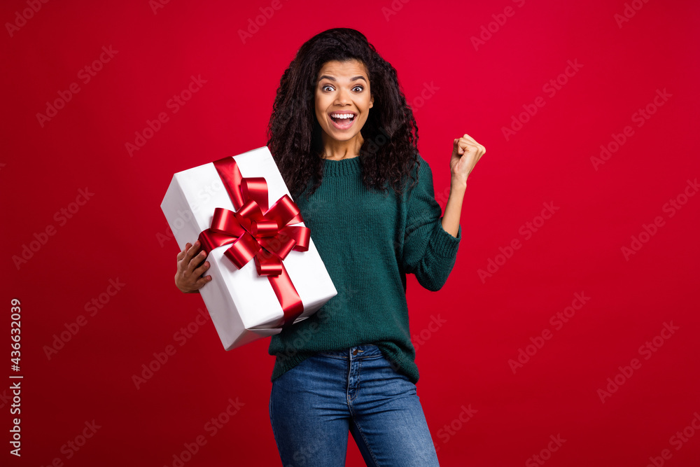 Photo of charming pretty cute afro american young woman hold hands gift winner isolated on red color background Photo of charming pretty cute afro american young woman hold hands gift winner isolated on red color background