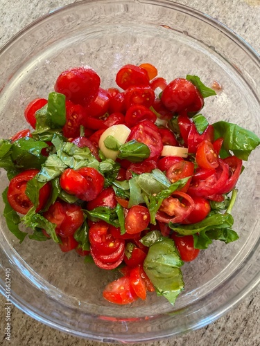 pomodorini basilico e aglio in ciotola per bruschetta photo