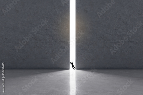 Expanding the boundaries of consciousness concept with man trying to move huge concrete wall to let in the light.