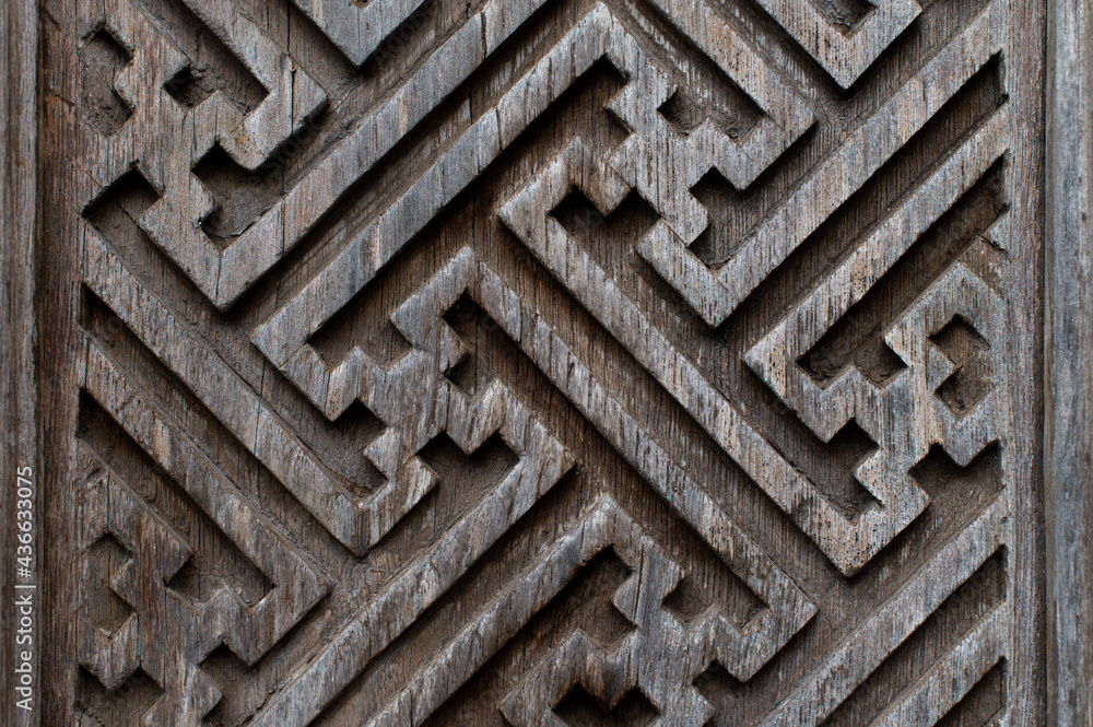 Balinese wood carving background. Graphic angular patterns on the doors.