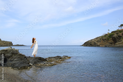 Full body of a lady breathing fresh air on the beach