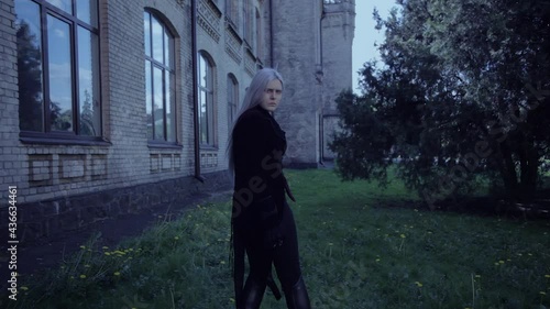 The terrible woman vampire reaches out and beckons. She is scary and beautiful.