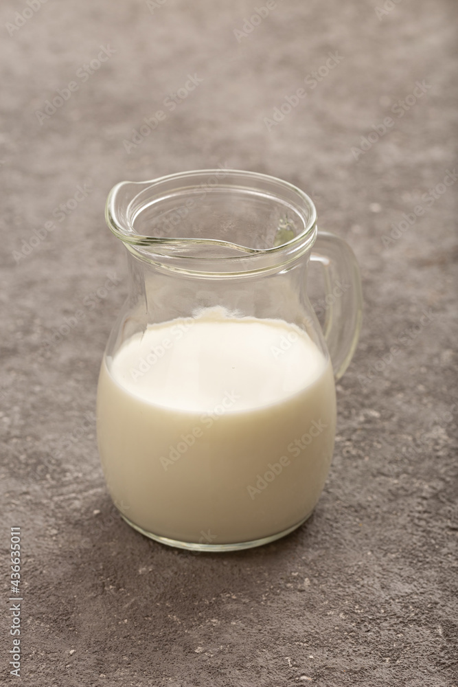 Jug of fresh milk close up on gray concrete Jug of fresh milk close up on gray concrete