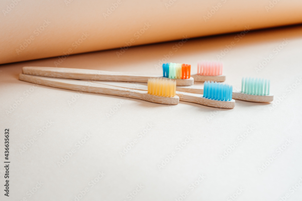 Colorful eco friendly bamboo toothbrushes on light pastel background, dental care with zero waste concept, sustainable lifestyle Colorful eco friendly bamboo toothbrushes on light pastel background, dental care with zero waste concept, sustainable lifestyle