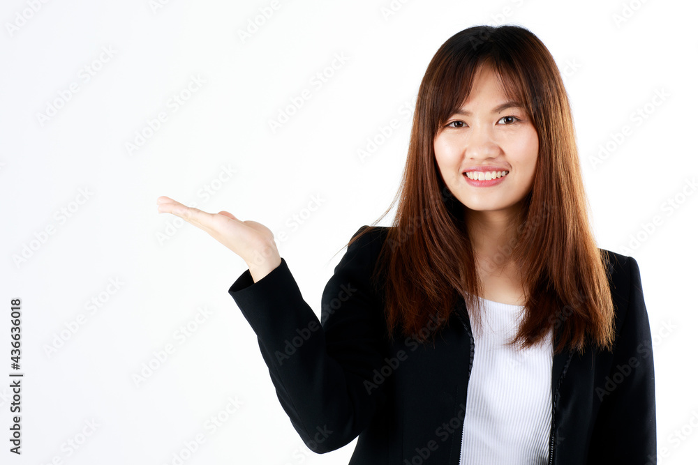Young and fresh new graduated look Asian businesswoman in black suit show hand palm to present or demonstrate goods and product in advertising gesture on white background Young and fresh new graduated look Asian businesswoman in black suit show hand palm to present or demonstrate goods and product in advertising gesture on white background