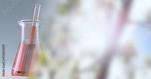 Composition of red liquid and stirrer in flask, with blurred pink blossom copy space to right