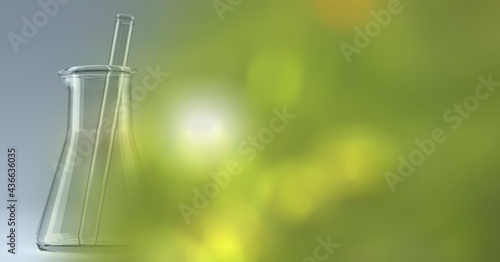Composition of stirrer in empty chemistry flask, with blurred green and yellow copy space to right