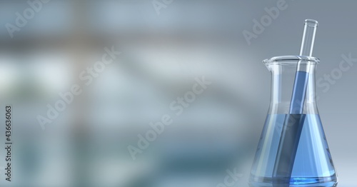 Composition of conical flask of blue liquid and stirrer, with blurred copy space