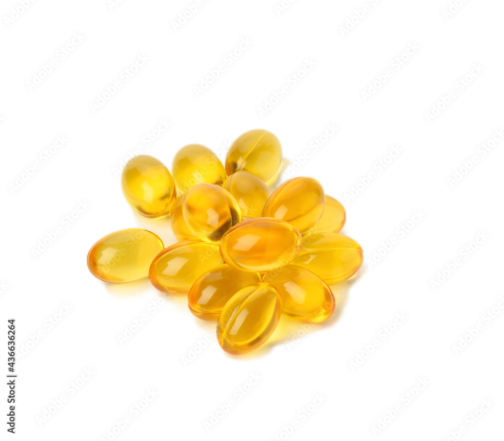 scattered oval tablets with fish oil, omega 3 on a white background scattered oval tablets with fish oil, omega 3 on a white background