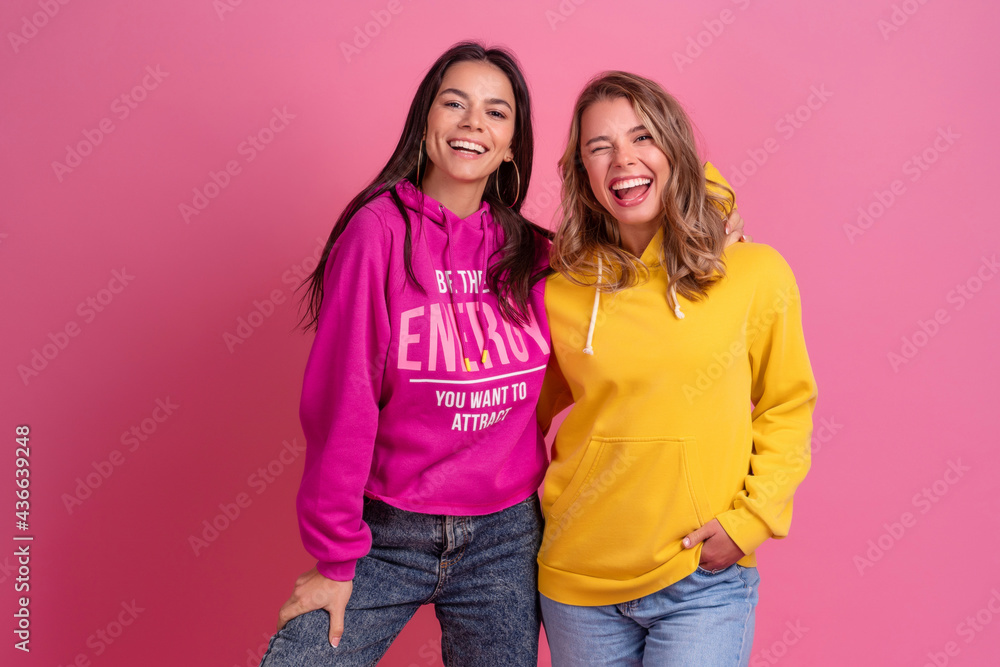 two pretty women friends embracing having fun together, blonde and brunette two pretty women friends embracing having fun together, blonde and brunette