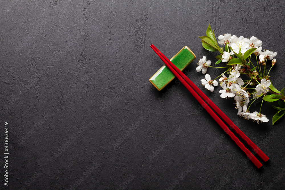 Japanese food with cherry blossom and sushi chopsticks Japanese food with cherry blossom and sushi chopsticks