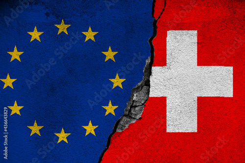 Obraz na płótnie Concept of the Conflict and the Relations between the European Union and Switzerland with painted flags on a wall with a crack and a hole in the middle w salonie
