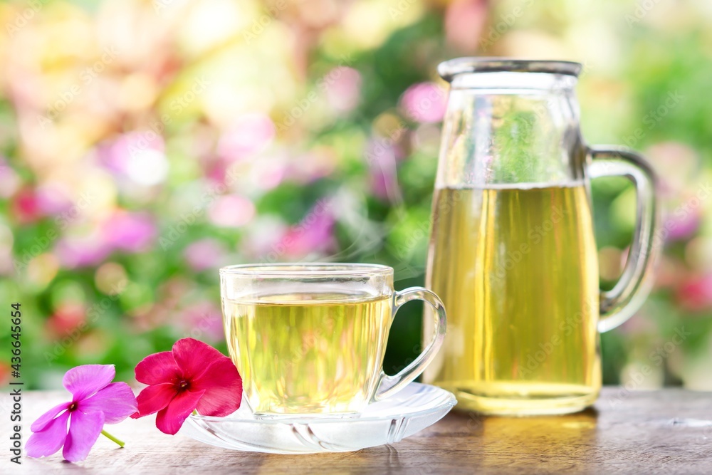 refreshment drink hot herbal tea glass on wooden table with background of nature in the morning refreshment drink hot herbal tea glass on wooden table with background of nature in the morning
