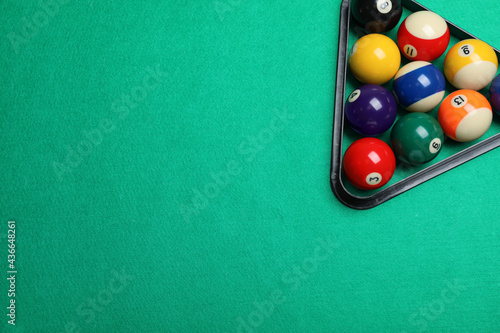 Canvas Print Plastic rack with billiard balls on green table, top view