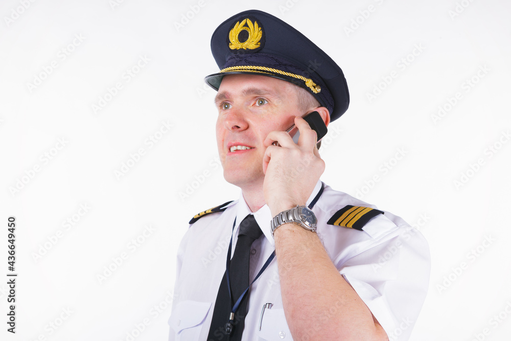 Fototapeta premium Airline captain pilot talking on the phone