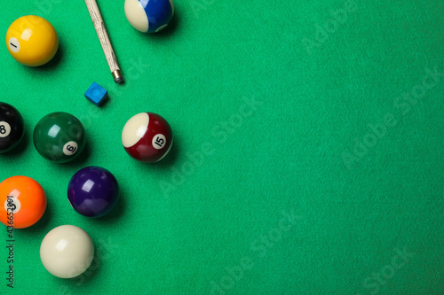 Flat lay composition with balls on billiard table, space for text
