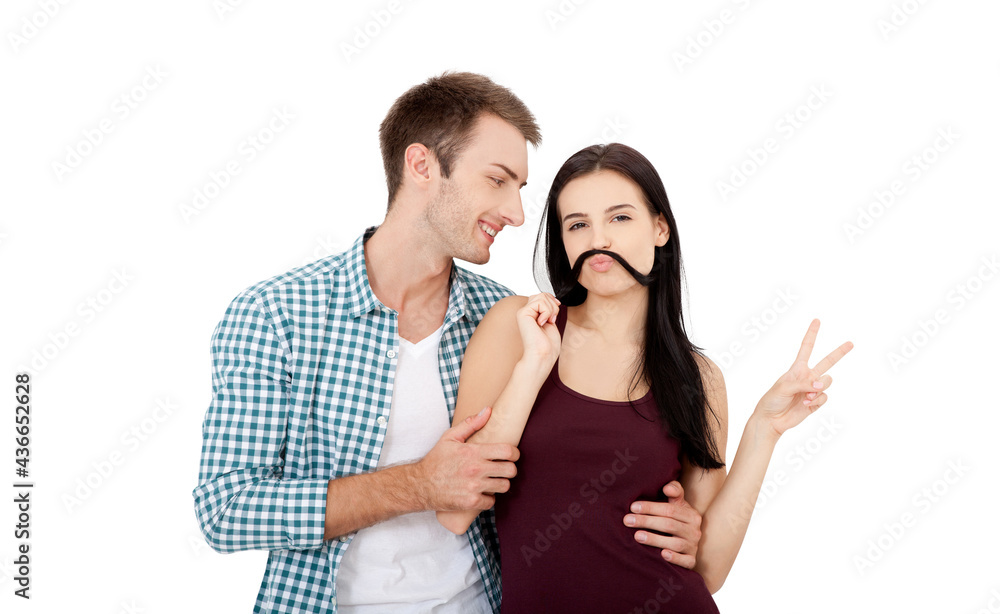 Playful couple fooling on valentine day. Beautiful young loving couple bonding to each other and smiling while making a fake mustaches from her hair