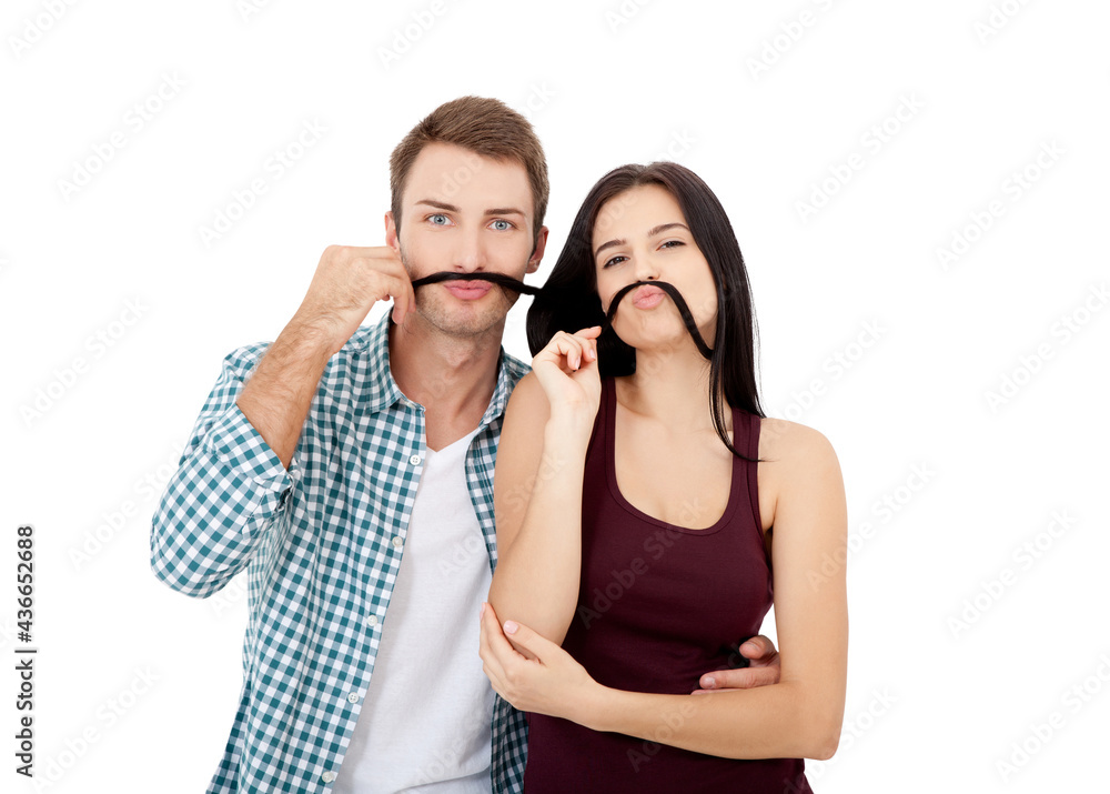 Playful couple fooling on valentine day. Beautiful young loving couple bonding to each other and smiling while making a fake mustaches from her hair Playful couple fooling on valentine day. Beautiful young loving couple bonding to each other and smiling while making a fake mustaches from her hair
