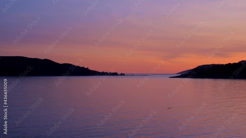 Amazing bright purple sunset on the Adriatic sea. Orange sky and blue water. Sunset in Montenegro, Balkans. Waves of the sea Amazing bright purple sunset on the Adriatic sea. Orange sky and blue water. Sunset in Montenegro, Balkans. Waves of the sea