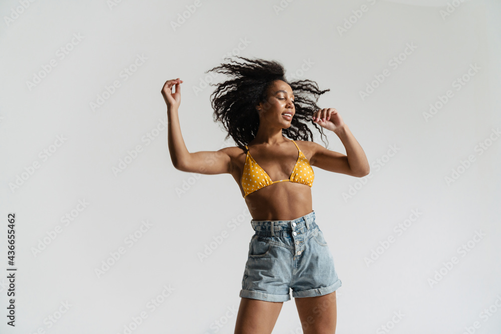 Black woman in swimsuit smiling and dancing on camera Black woman in swimsuit smiling and dancing on camera