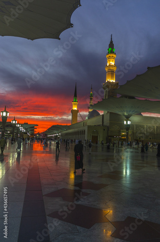 Awesome shots of Nabawi Masjid with Red and Blue mixed color sku during sunset  photo