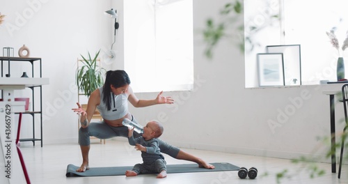 Mom and child do fitness at home during isolation