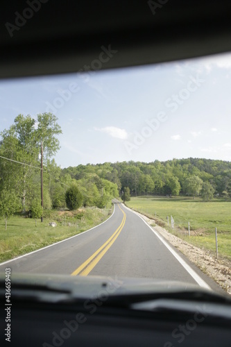country road from inside vehicle during road trip travel