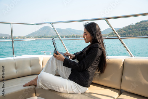 Asian young businesswoman with laptop at the yacht in summer © ic36006