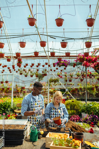 Two diverse people working in a garden center