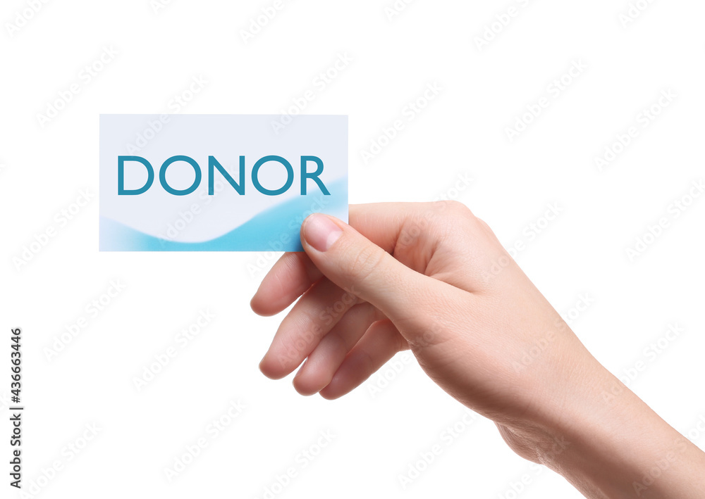 Woman holding card with word DONOR on white background, closeup Woman holding card with word DONOR on white background, closeup