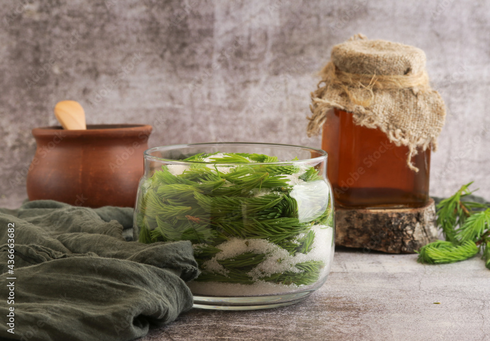 Obraz premium Young shoots of spruce and oil,and tincture in a ceramic dish.Ecological preparations.