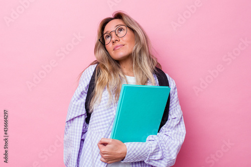 Young student australian woman isolated on pink background dreaming of achieving goals and purposes