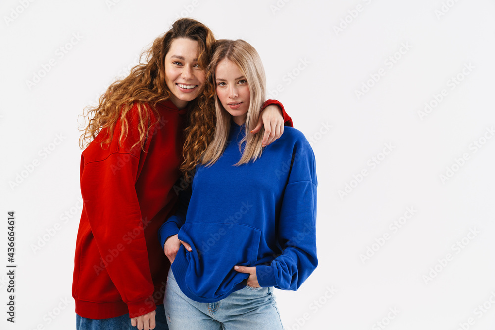 Young white two women hugging while smiling at camera