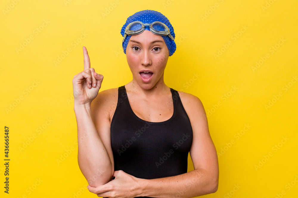 Young australian swimmer woman isolated on yellow background having some great idea, concept of creativity. Young australian swimmer woman isolated on yellow background having some great idea, concept of creativity.