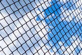 Chain link fence and sky background.
