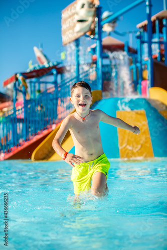 Fototapeta Naklejka Na Ścianę i Meble -  Happy little boy in pool at aqua park