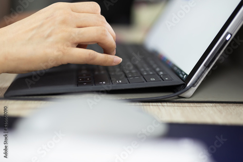 Close up of business woman hand typing on laptop keyboard work at home.