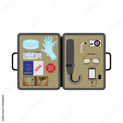 Open traveler's briefcase. Top view. Essential items. Medical mask, gloves. Transport ticket, passport, visa, insurance. Wallet, cash, credit cards. Umbrella, camera, sunglasses. Mobile phone, charger