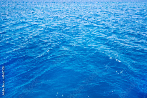 Blue water with sun reflections. Sea background