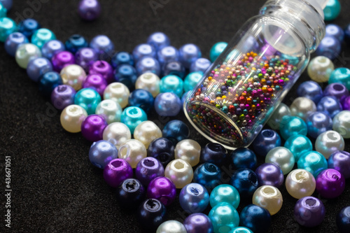 beads and bottles on a black background