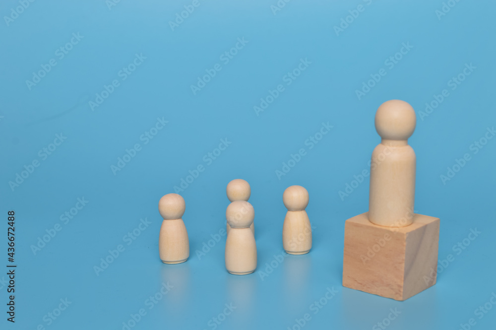 Wooden doll figures with their leader. Communication and social network Wooden doll figures with their leader. Communication and social network