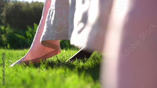 Edge of a pink tablecloth falling to the grass