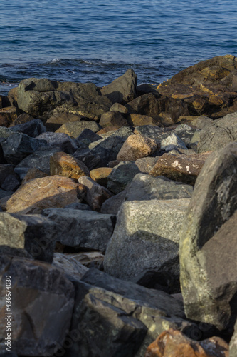Rocky shoreline in warm sunlight © lunarvogel
