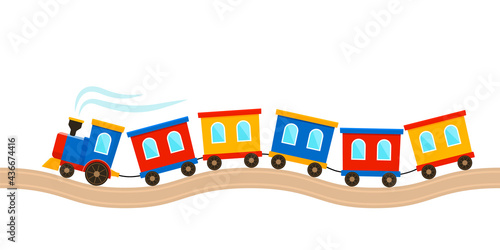a toy of a children's train with colored carriages rushes along the rails.